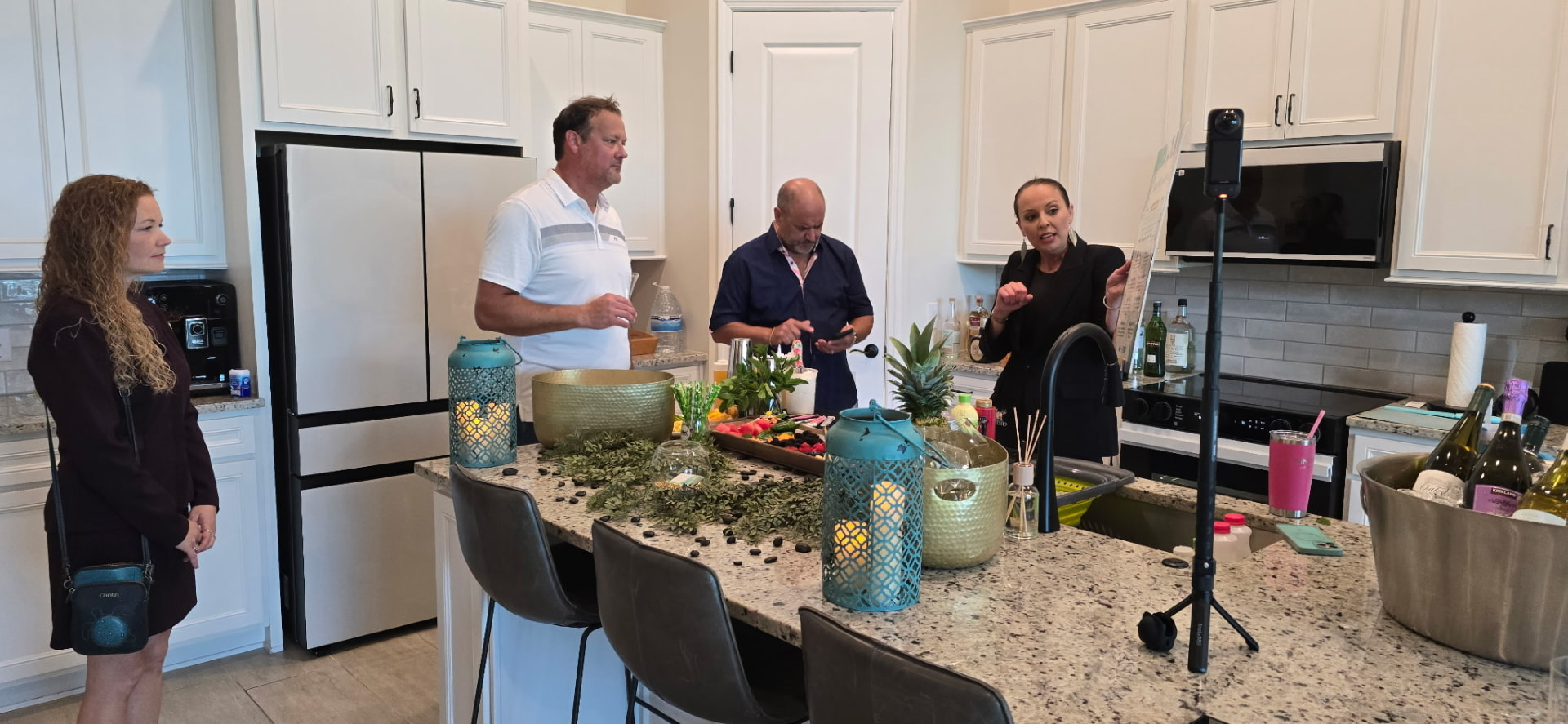 Hosts presenting the evening's flight menu around a kitchen island