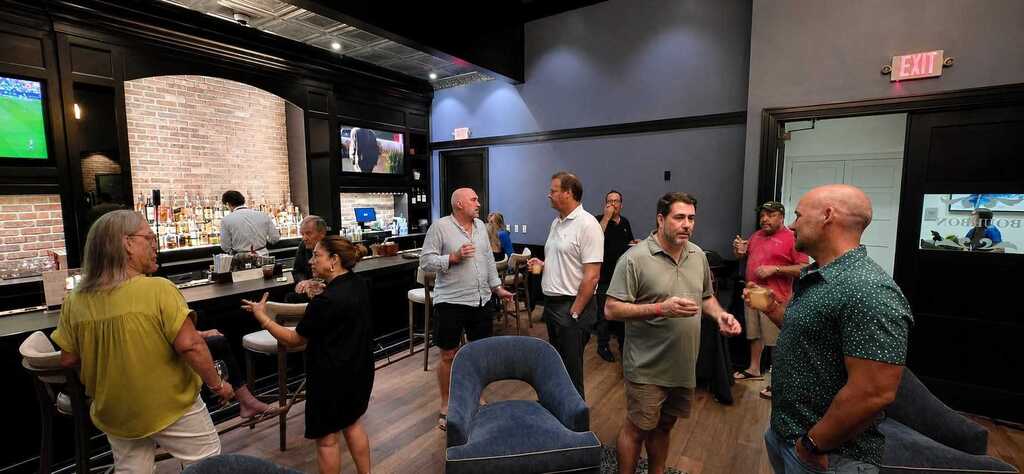 Guests in conversation at an evening lounge bar during an OPEN ΛXIS event